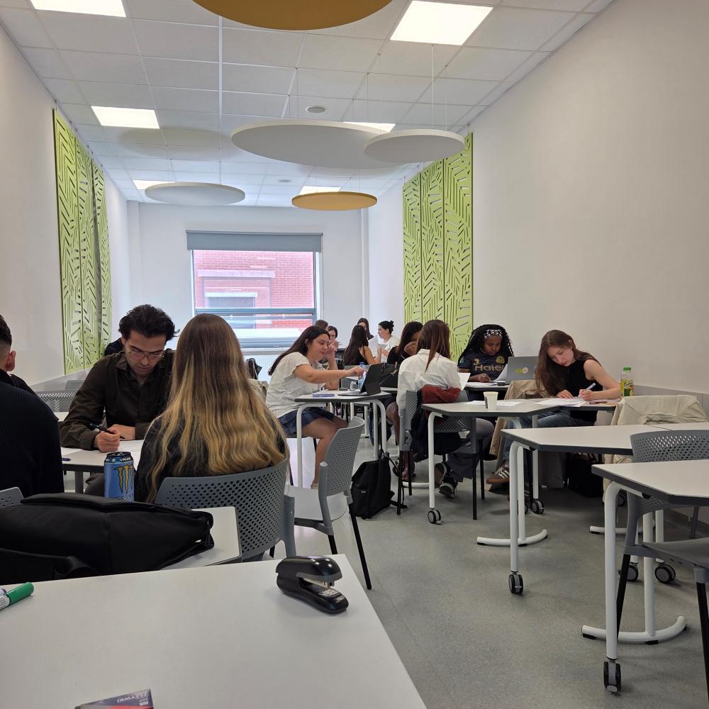 International students work in groups in a university classroom